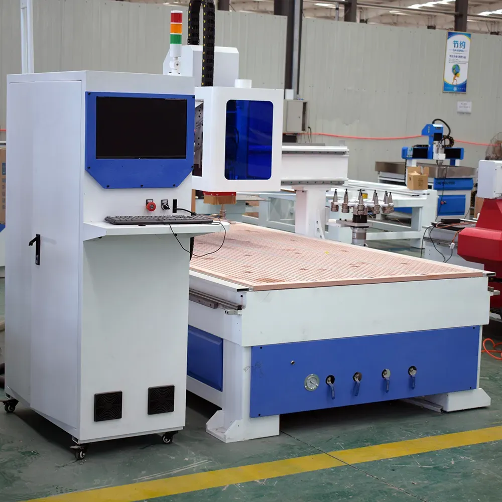 Profitable 4x8 Carousel ATC CNC Router with Dust Cover 7 Front-left view highlighting independent CNC control console with keyboard tray, MPG handwheel, and tri-color warning tower